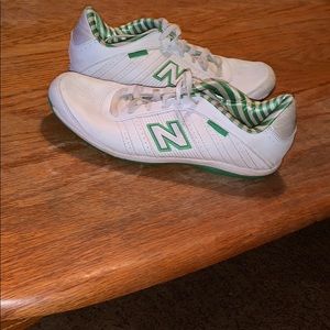 Green and white new balance tennis shoes.